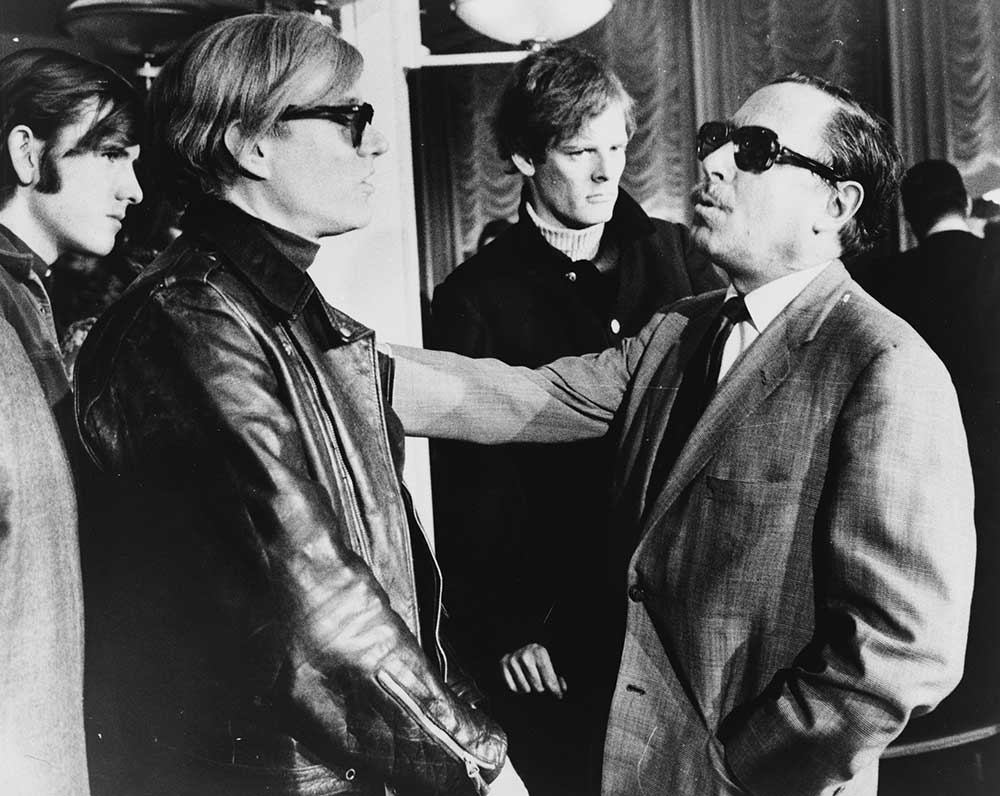 Andy Warhol (left) and Tennessee Williams (right) talking on the SS France (1967)