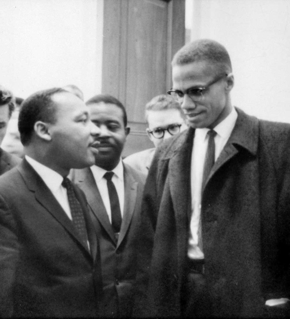 Malcolm X (right) meeting with Martin Luther King Jr. (left) (1964)