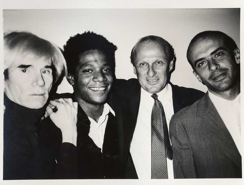 Andy Warhol (left) with Jean-Michel Basquiat (middle left), Bruno Bischofberger (middle right), and Francesco Clemente (right) in 1984