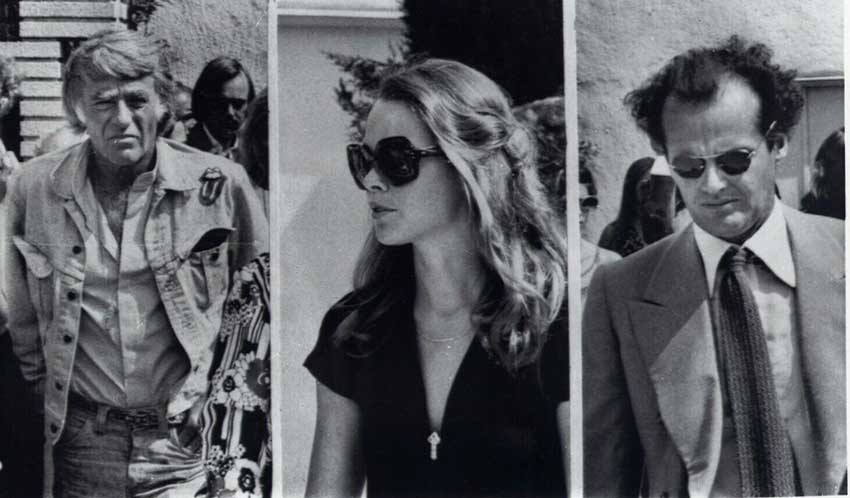 Peter Lawford (left), Michelle Phillips (middle), and Jack Nicholson (right) at the funeral for Cass Elliot in 1974