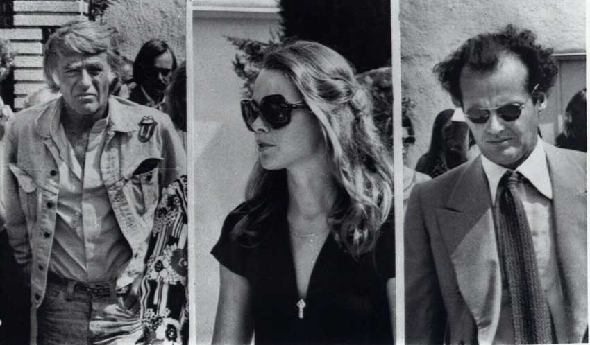 Peter Lawford (left), Michelle Phillips (centre), and Jack Nicholson (right) at the funeral for Cass Elliot (1974)