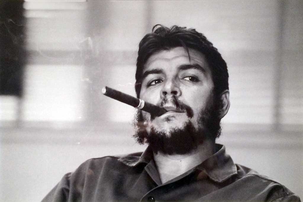 Che Guevara being interviewed while smoking a cigar (1963)