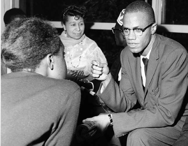 Malcolm X (right) at a welcoming event for the African-American Students Foundation in 1959 or 1960.