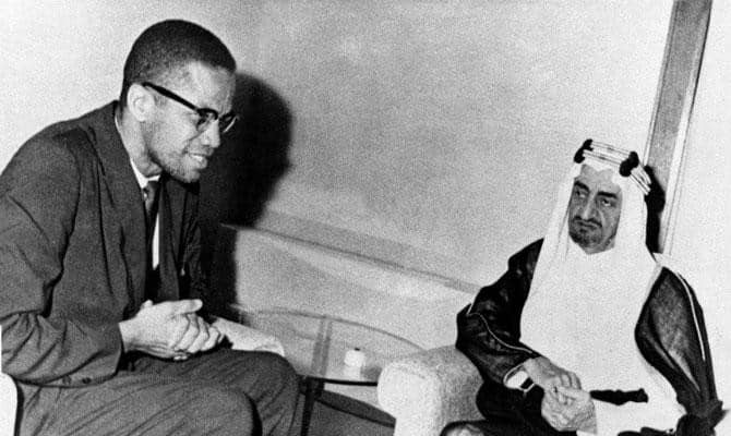 Malcolm X (left) meeting with then Crown Prince Faisal Al-Saud (right) in Jeddah, Saudi Arabia (1964)