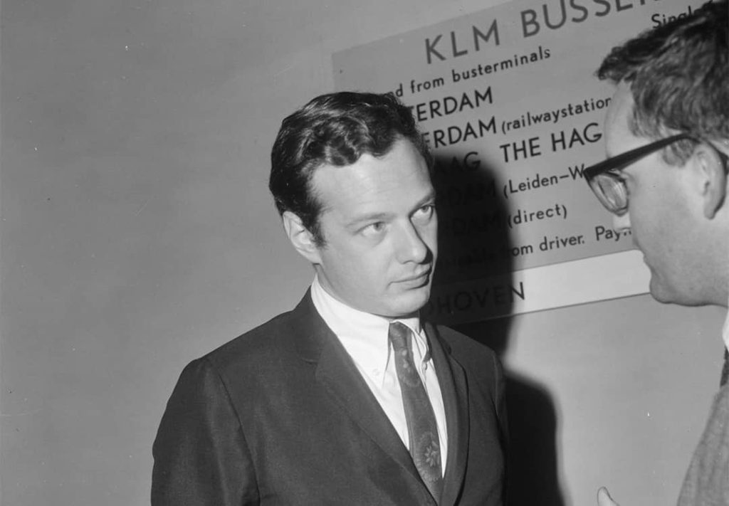 Brian Epstein at the Schiphol airport in Amsterdam, Netherlands talking to what appears to be a journalist (1965)