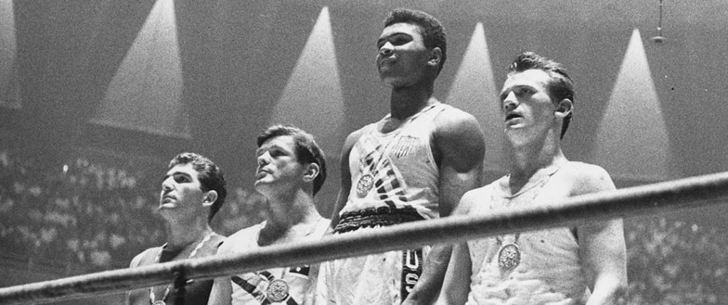 A young Mohammed Ali wins first prize at the boxing light-heavyweight 1960 Olympics. From left to right: Giulio Saraudi (ITA), Tony Madigan (AUS), Muhammad Ali (USA), and Zbigniew Pietrzykowski (POL)