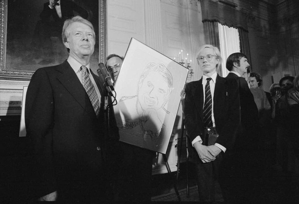 Jimmy Carter (left) with Andy Warhol (right) during a reception for inaugural portfolio artists (1977)