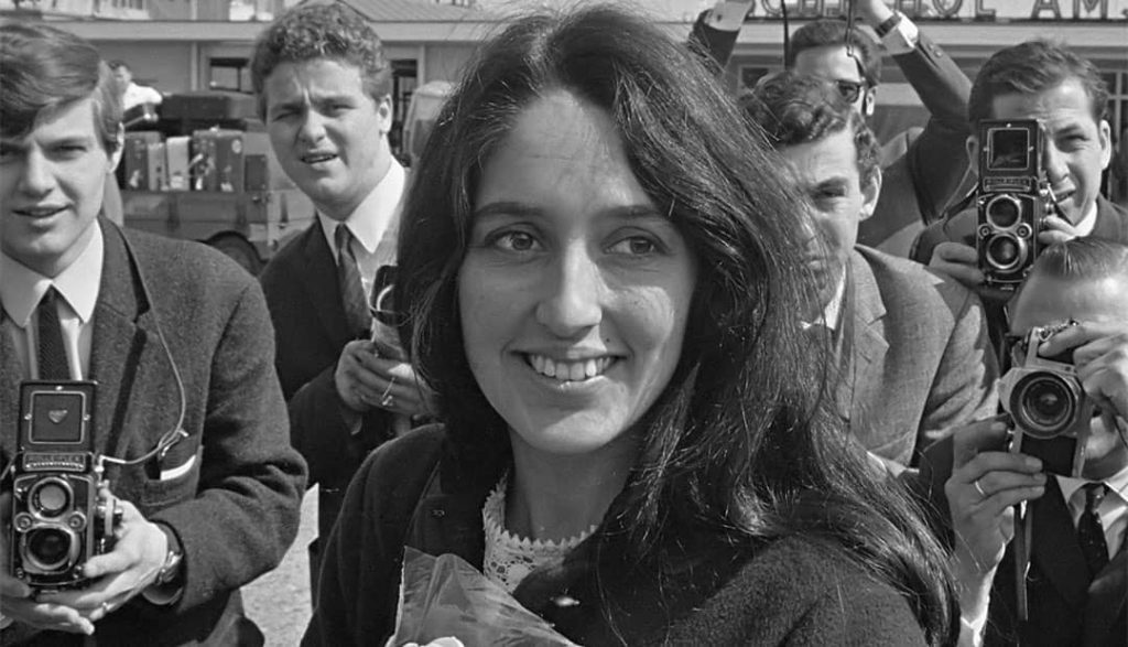 Joan Baez arriving at the Schiphol airport in Amsterdam, Netherlands (1966)