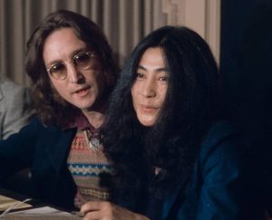 John Lennon (left) and Yoko Ono (right) at a New York press conference where they would announce the conceptual country of Nutopia (1973)
