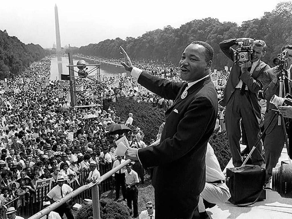 Martin Luther King Jr. saluting the masses in front of the Washington Monument