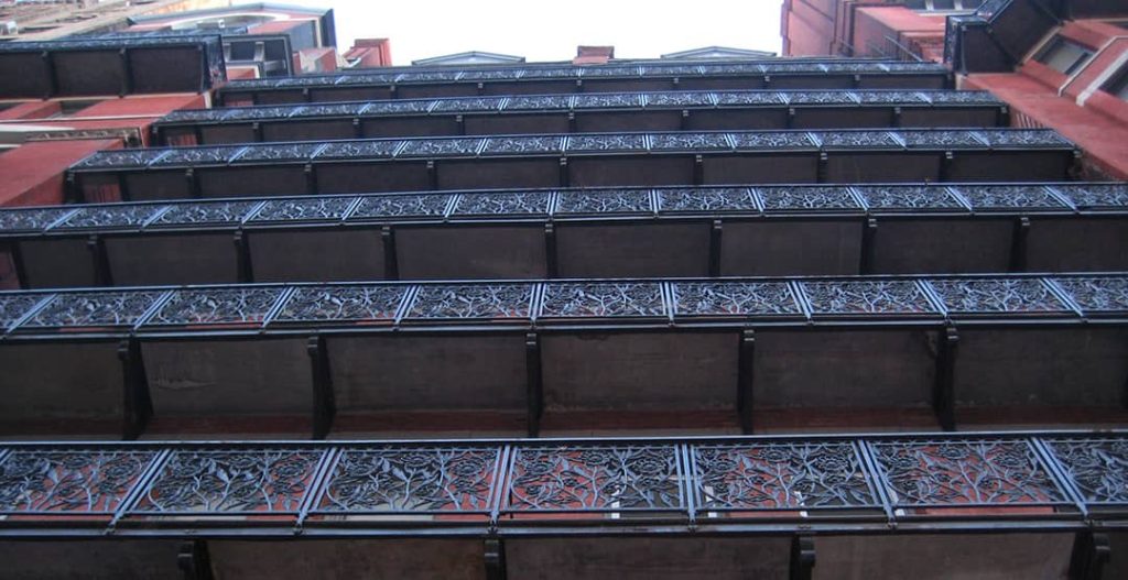 Low angle photograph of the Chelsea Hotel façade and its iconic flower-ornamented iron balconies (2011)