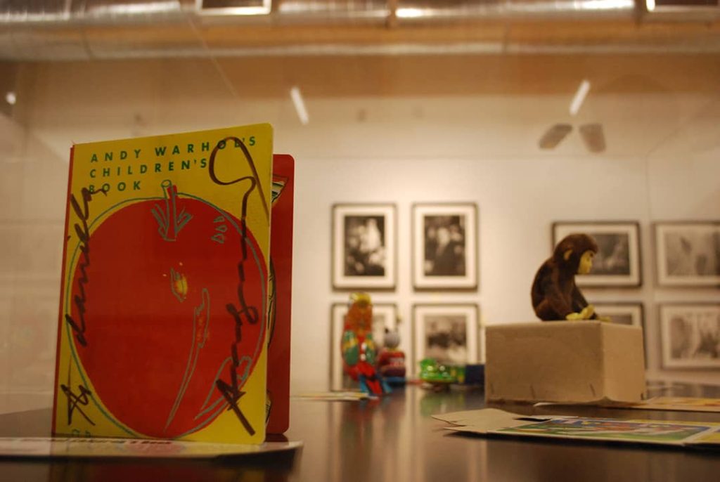 Photo of a book and a stuffed monkey taken at the Andy Warhol's Factory exhibit hosted at the Waterloo Region Children's Museum in Kitchener, Ontario, Canada (2009)