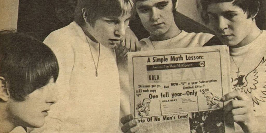 English mod band "John's Children" reading an issue of KLRA Beat newspaper in which they were featured. From left to right: John Hewlett, Andy Ellison, Chris Townson and Marc Bolan (1967)