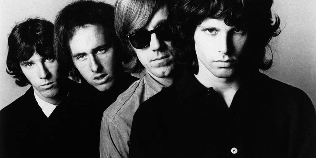 Promotional photo of The Doors. From left to right: John Densmore, Robby Krieger, Ray Manzarek, and Jim Morrison (1966)